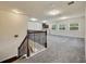Bonus room with neutral carpet, staircase, and wet bar in an open floor plan at 1229 Hillandale Reserve Dr, Tampa, FL 33613