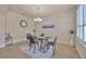 Dining area with a glass table, seating for four, and minimalist decor at 1229 Hillandale Reserve Dr, Tampa, FL 33613