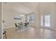 Dining area with modern chandelier, glass table, seating for four, and shuttered windows at 1229 Hillandale Reserve Dr, Tampa, FL 33613