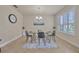 Dining area with modern glass table, gray chairs, and shuttered window with natural light at 1229 Hillandale Reserve Dr, Tampa, FL 33613