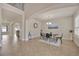 Bright dining room featuring tile flooring, a modern chandelier, and a glass-top dining table at 1229 Hillandale Reserve Dr, Tampa, FL 33613