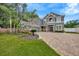 Beautiful two-story home featuring a landscaped front yard, brick accents, palm trees, and a brick paved circular driveway at 1229 Hillandale Reserve Dr, Tampa, FL 33613