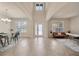 Bright foyer with tile flooring, high ceilings, decorative front door, and dining and sitting areas at 1229 Hillandale Reserve Dr, Tampa, FL 33613