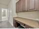 Hallway featuring a built-in desk area with upper cabinets and granite countertop at 1229 Hillandale Reserve Dr, Tampa, FL 33613