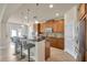 Well-lit kitchen showcasing a breakfast bar with seating, granite countertops, and stainless steel appliances at 1229 Hillandale Reserve Dr, Tampa, FL 33613