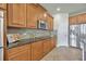Kitchen showcasing updated cabinets, stainless steel appliances, and tile backsplash at 1229 Hillandale Reserve Dr, Tampa, FL 33613