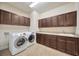 Well-appointed laundry room boasts ample cabinetry, countertop space, and modern appliances at 1229 Hillandale Reserve Dr, Tampa, FL 33613