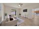 The bright living room includes a ceiling fan, tile flooring, and a view into the kitchen at 1229 Hillandale Reserve Dr, Tampa, FL 33613