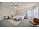 Bright and spacious main bedroom features a ceiling fan, soft carpet, and lots of natural light at 1229 Hillandale Reserve Dr, Tampa, FL 33613