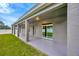 Covered patio with sliding glass door and lawn at 1229 Hillandale Reserve Dr, Tampa, FL 33613