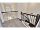 Elegant staircase with dark wood and iron railing leading to the upper level at 1229 Hillandale Reserve Dr, Tampa, FL 33613
