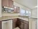Well-lit wet bar with granite countertops, stainless steel appliances, and wood cabinetry at 1229 Hillandale Reserve Dr, Tampa, FL 33613