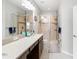 Bright bathroom featuring double sinks and a stand up glass shower at 12353 Bayou Flats Ln, Tampa, FL 33635