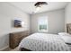 Comfortable bedroom features a ceiling fan, natural light, and dresser under a wall mounted TV at 12353 Bayou Flats Ln, Tampa, FL 33635