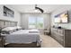 Cozy bedroom with a large bed, ceiling fan, and natural light at 12353 Bayou Flats Ln, Tampa, FL 33635