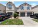 Charming two-story townhome with attached garages, manicured lawn, and stone accents at 12353 Bayou Flats Ln, Tampa, FL 33635