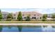 Rear exterior view showing a tranquil lake and green space behind the property at 12353 Bayou Flats Ln, Tampa, FL 33635