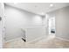 Bright hallway with neutral carpet and an open doorway to a bedroom at 12353 Bayou Flats Ln, Tampa, FL 33635