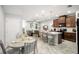 Open-concept kitchen with modern appliances, center island, and adjacent dining area at 12353 Bayou Flats Ln, Tampa, FL 33635