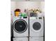 Convenient laundry room with modern front-loading washer and dryer and wire shelving for storage at 12353 Bayou Flats Ln, Tampa, FL 33635