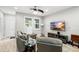 Cozy living room with neutral tones, ceiling fan, and a mounted television at 12353 Bayou Flats Ln, Tampa, FL 33635