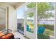 Inviting patio with lake view, featuring two chairs with orange cushions and artificial turf at 12353 Bayou Flats Ln, Tampa, FL 33635