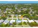Neighborhood aerial view surrounded by lush trees and foliage at 1263 Overcash Dr, Dunedin, FL 34698
