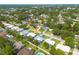 Aerial view showcases the neighborhood's mature trees and residential homes with tidy yards at 1263 Overcash Dr, Dunedin, FL 34698