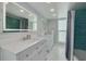 Bathroom featuring double sinks, marble countertops, and modern fixtures at 1263 Overcash Dr, Dunedin, FL 34698