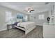 Spacious bedroom featuring wood floors, modern furniture, and stylish decor at 1263 Overcash Dr, Dunedin, FL 34698