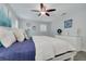 Bright bedroom with wood floors, modern decor, and a comfortable bed with white linens at 1263 Overcash Dr, Dunedin, FL 34698