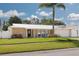 Charming single-story home with a well-manicured lawn and tropical landscaping, located in a serene neighborhood at 1263 Overcash Dr, Dunedin, FL 34698