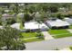 Aerial view of the property's manicured front yard and mature landscaping at 1263 Overcash Dr, Dunedin, FL 34698