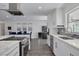 Well-equipped kitchen with stainless steel appliances, a breakfast bar, and an open view to the adjacent dining area at 1263 Overcash Dr, Dunedin, FL 34698