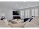 Cozy living room featuring a large sectional sofa, plantation shutters, and recessed lighting for a bright, inviting space at 1263 Overcash Dr, Dunedin, FL 34698