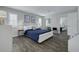 Comfortable bedroom with modern decor, plantation shutters, and ample natural light, providing a serene retreat at 1263 Overcash Dr, Dunedin, FL 34698