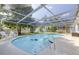 This large screened pool features a hot tub and plenty of space for relaxing and entertaining at 1263 Overcash Dr, Dunedin, FL 34698
