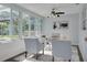 Bright sunroom featuring floor-to-ceiling windows, comfortable seating, and view of pool at 1263 Overcash Dr, Dunedin, FL 34698