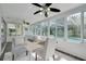Enclosed sunroom offering ample natural light, comfortable seating, and pool view at 1263 Overcash Dr, Dunedin, FL 34698