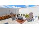 Backyard with a cozy seating area around a fire pit, bordered by white gravel and a white fence at 12925 Fieldmoor Ct, Riverview, FL 33579