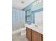 Bright bathroom featuring a shower/tub combo, single sink vanity, and tile flooring at 12925 Fieldmoor Ct, Riverview, FL 33579