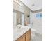 Standard bathroom with a tile floor, neutral color, a tub with a shower, and a good-sized vanity at 12925 Fieldmoor Ct, Riverview, FL 33579