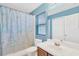 Cozy bathroom featuring a shower with a curtain, a large mirror and wood vanity at 12925 Fieldmoor Ct, Riverview, FL 33579