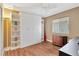 Bedroom features wood floors, a ceiling fan, and built in storage cabinets at 12925 Fieldmoor Ct, Riverview, FL 33579