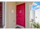 Eye-catching red front door, complemented by decorative plants and clean landscaping at 12925 Fieldmoor Ct, Riverview, FL 33579