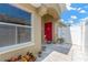 Inviting entryway with a bright red door and well maintained landscaping at 12925 Fieldmoor Ct, Riverview, FL 33579