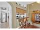 Kitchen pass-through featuring wood cabinets and granite counters with bar seating at 12925 Fieldmoor Ct, Riverview, FL 33579