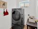 Laundry room showcases a modern washer and dryer set with a storage table at 12925 Fieldmoor Ct, Riverview, FL 33579