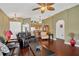 Inviting living room showcasing hardwood floors, green walls, and open access to the kitchen and dining areas at 12925 Fieldmoor Ct, Riverview, FL 33579