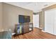 Cozy living room with laminate floors, a media console, and closet doors at 12925 Fieldmoor Ct, Riverview, FL 33579